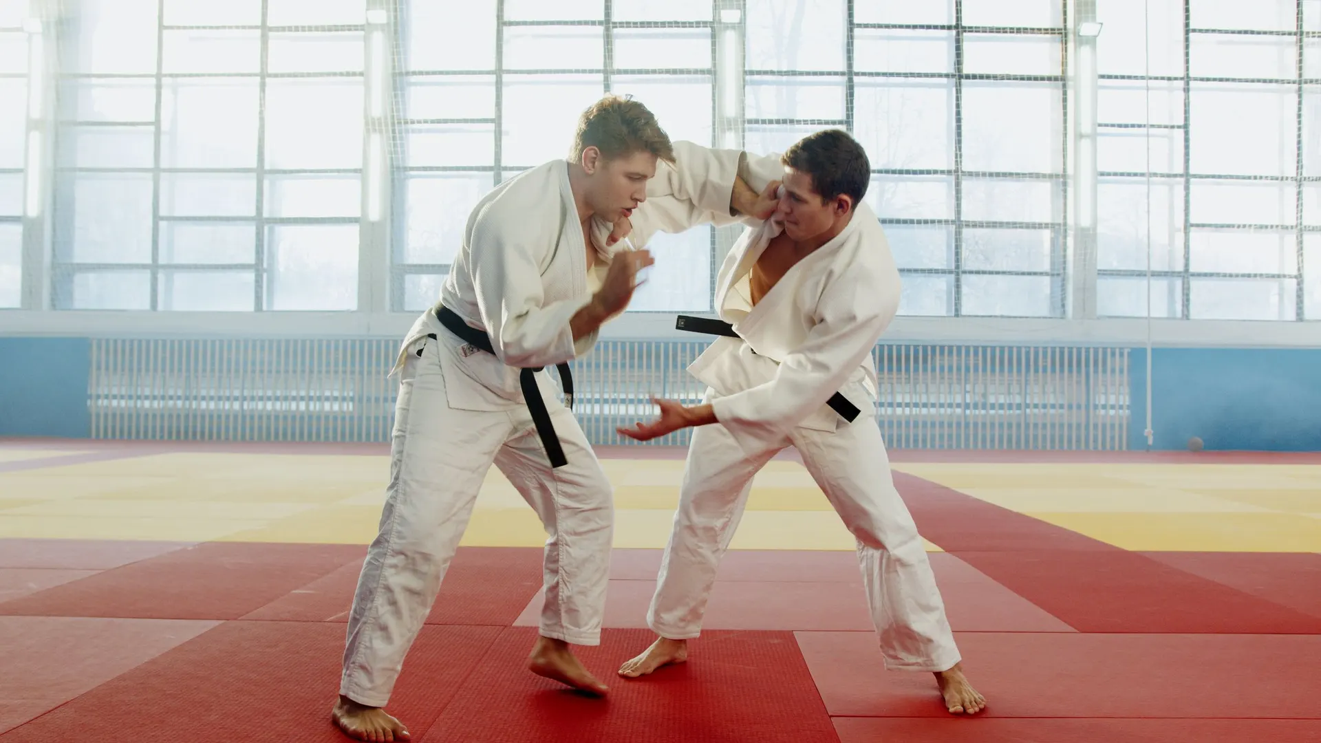 Two judoka fighting for grips on the tatami
